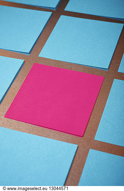 High angle view of blue and pink papers arranged on table