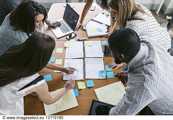 High angle view of business people brainstorming in board room