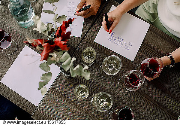 High angle view of businesswoman writing on paper during kick off meeting at convention center