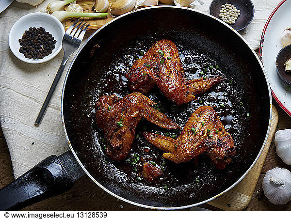 High angle view of chicken meat in cooking pan on table