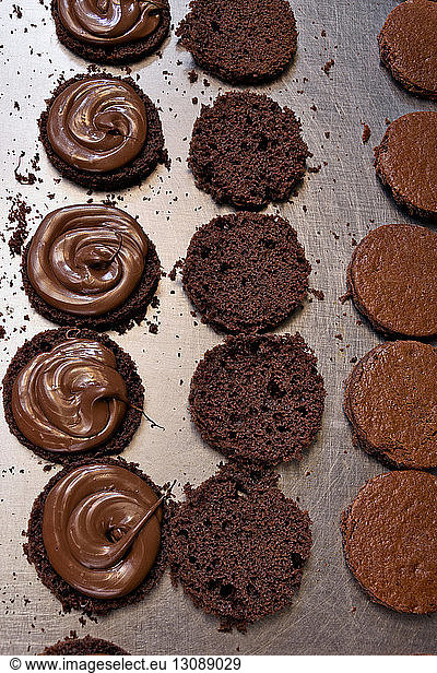High angle view of chocolate sponge cakes on kitchen counter at factory