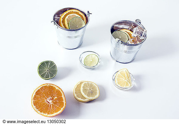 High angle view of citrus fruits with containers on table