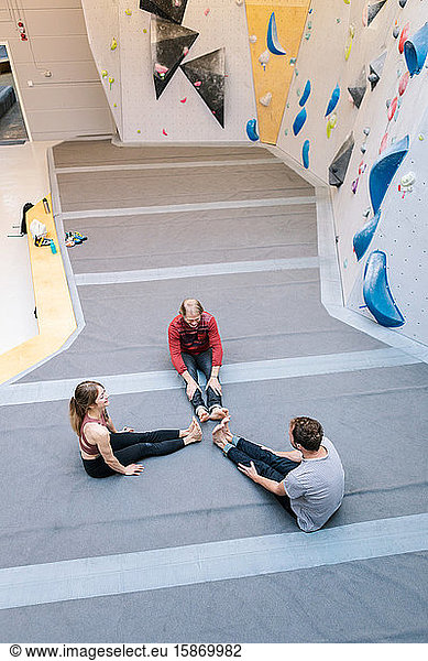 High angle view of coach training male and female students at gym