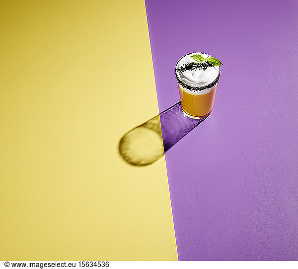 High angle view of cocktail on colored background