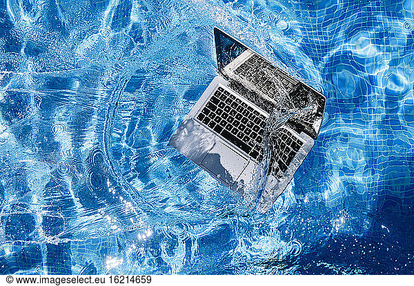 High angle view of computer floating on swimming pool