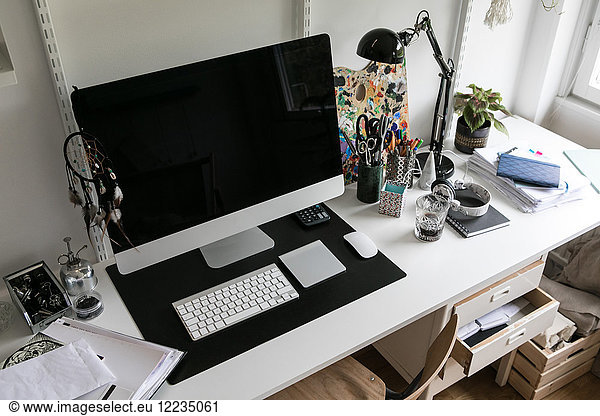 High angle view of computer with office supplies on desk at home