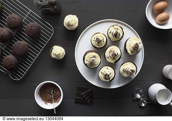 High angle view of cupcakes and chocolate chip muffins on table
