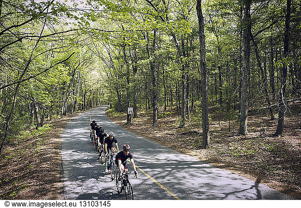 High angle view of cyclists riding bicycles on country road