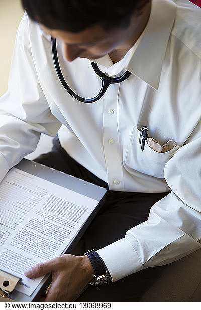 High angle view of doctor reading document