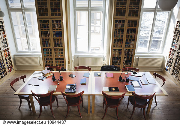 High angle view of empty chairs with table in board room at law library