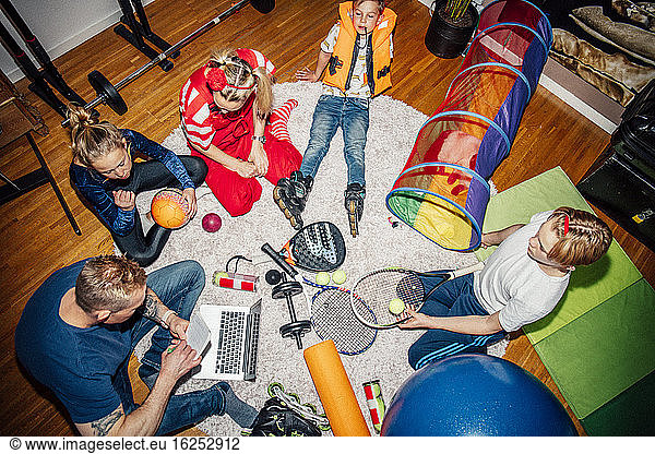 High angle view of family sitting on floor
