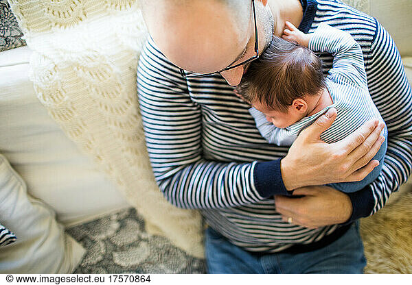 high angle view of father holding  loving his newborn son.