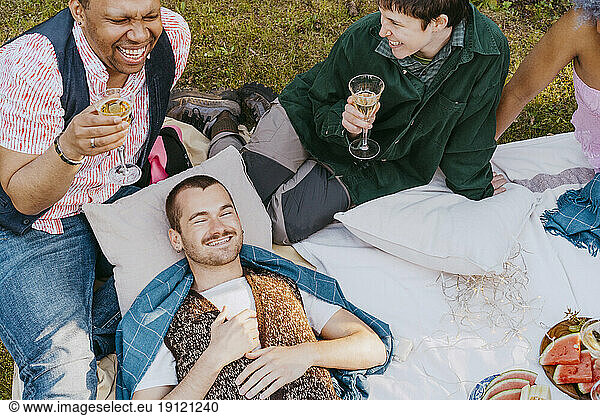 High angle view of friends from LGBTQ community having fun during dinner party in back yard