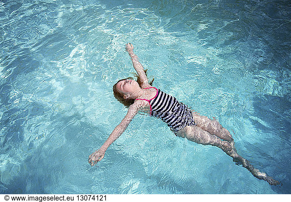 High angle view of girl in swimwear swimming in pool