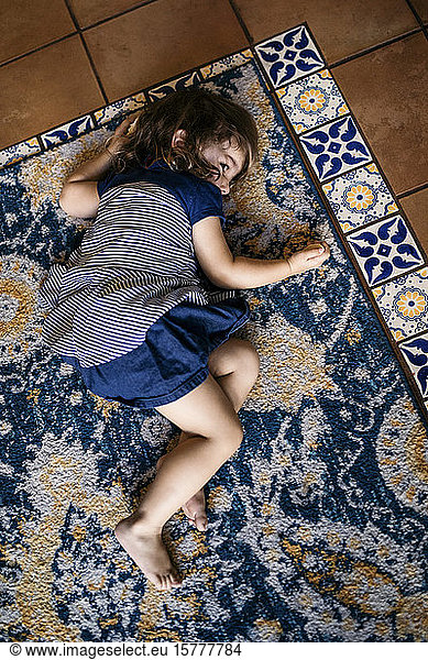 High angle view of girl lying on carpet