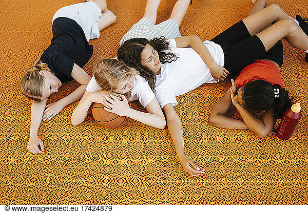High angle view of girls lying down on court