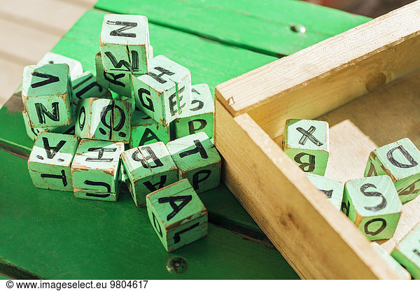 High angle view of green wooden blocks on table outside kindergarten