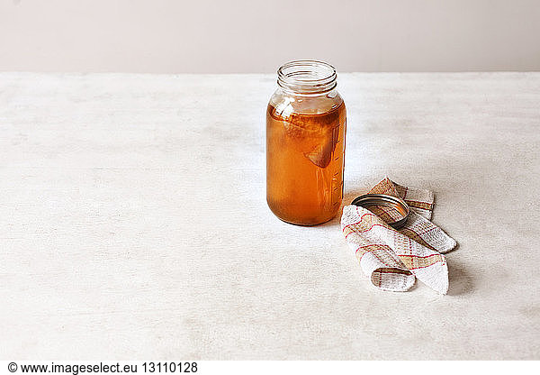 High angle view of honey jar on table
