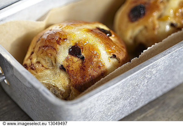High angle view of hot cross buns in container