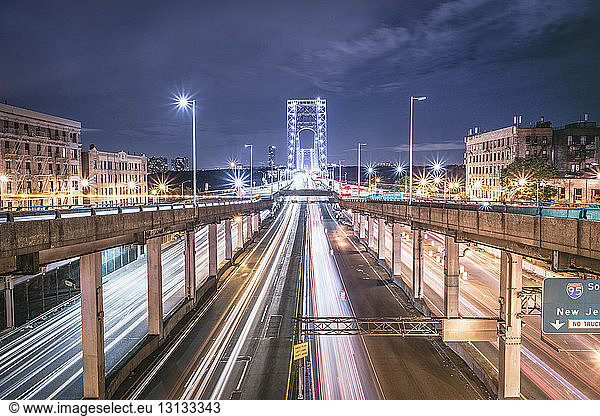 High angle view of light trails on George Washington Bridge against sky at night