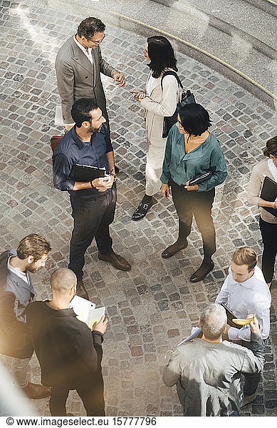 High angle view of male and female business people standing outdoors
