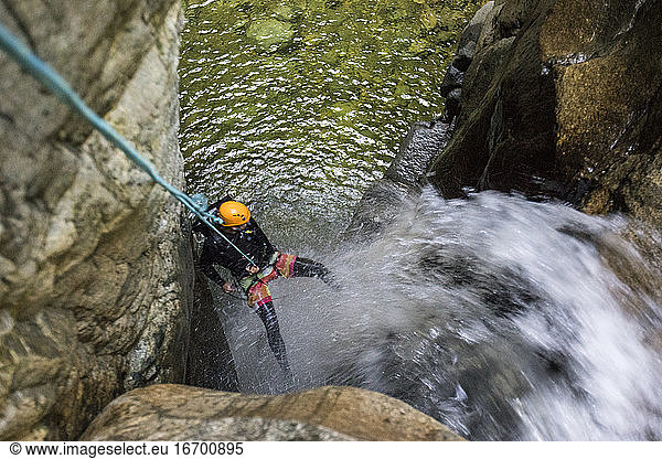 High angle view of man rappelling in down waterfall  West Vancouver.