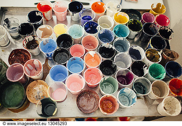 High angle view of messy watercolor paint glasses