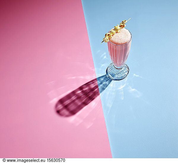 High angle view of milkshake on colored background