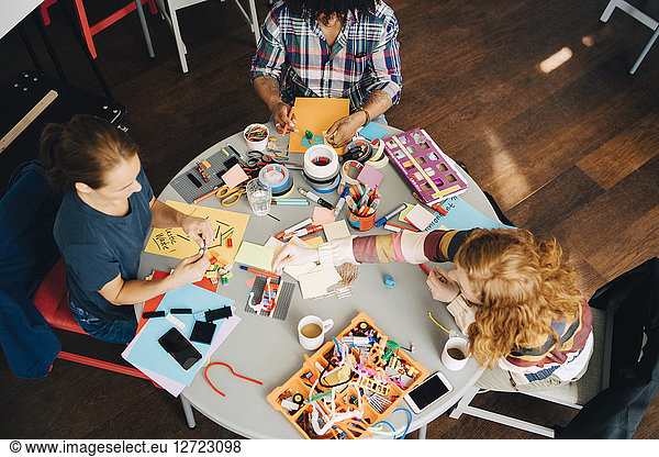 High angle view of multi-ethnic engineers working at table in creative office