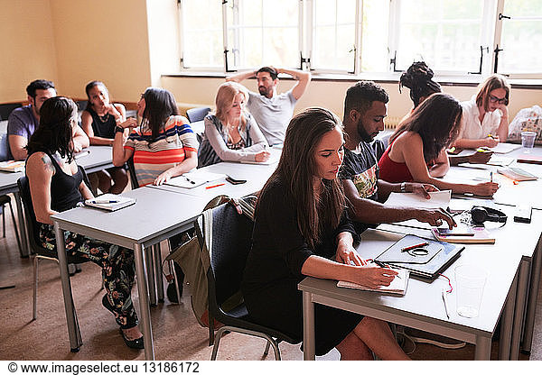 High angle view of multi-ethnic students studying in classroom