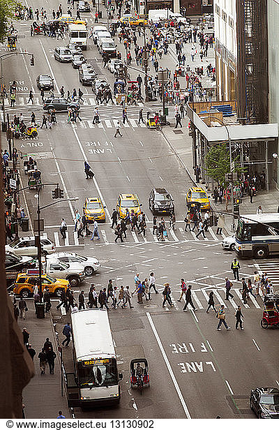 High angle view of people crossing city street