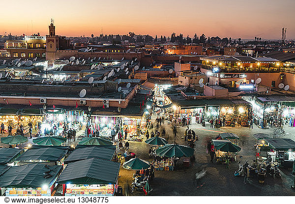 High angle view of people shopping at Marrakesh market during night in city
