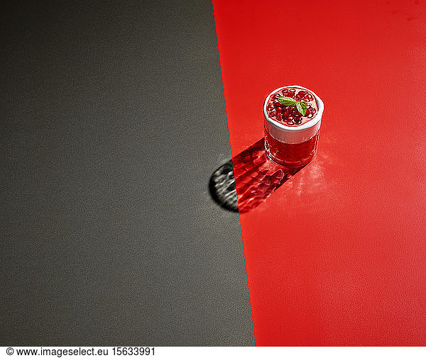High angle view of pomegranate drink on colored background
