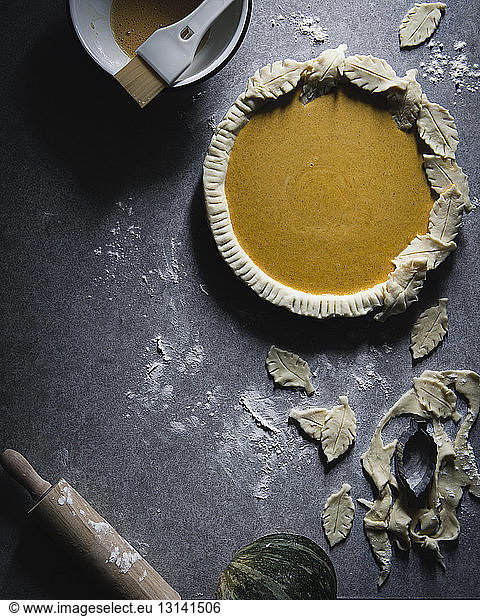 High angle view of pumpkin pie with dough on table