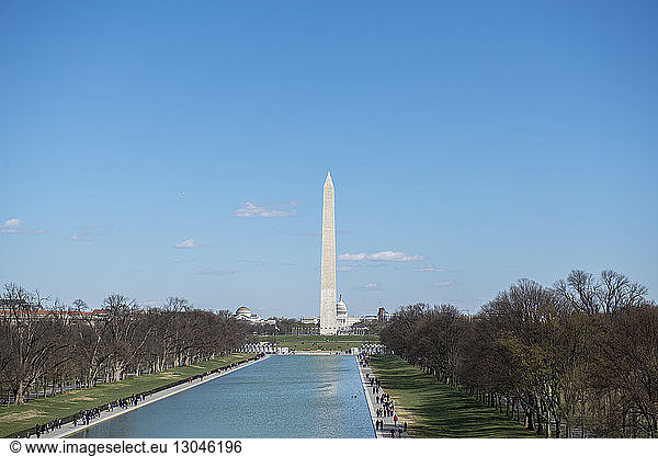 High angle view of Reflecting Pool by Washington Monument against sky during sunny day