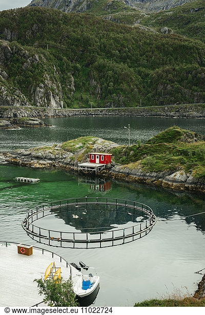 High angle view of salmon fish farm by mountain