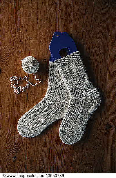 High angle view of socks and string on wooden table