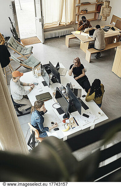 High angle view of startup business colleagues working together in office