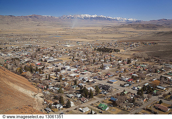 High angle view of townscape against snowcapped mountains