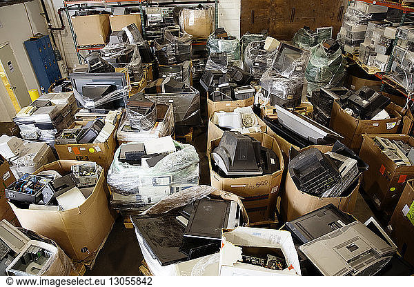 High angle view of various electrical equipments in boxes at recycling plant