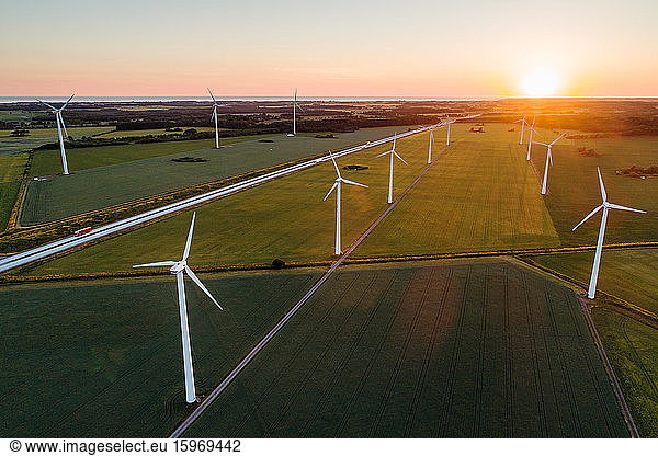 High angle view of wind turbines on grassy field against clear sky