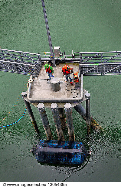 High angle view of workers at oil refinery