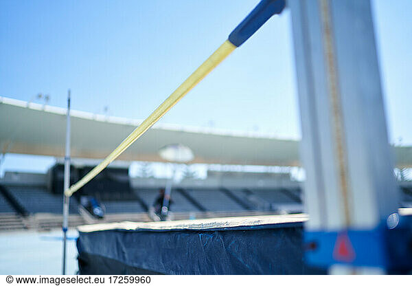 High jump pole and padding in sunny stadium
