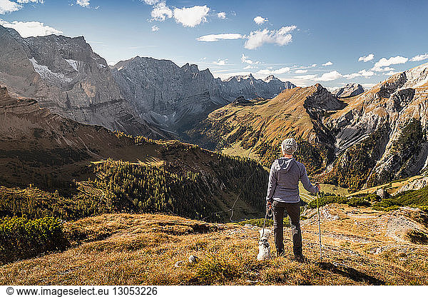 Hiker and pet dog enjoying view  Karwendel region  Hinterriss  Tirol  Austria