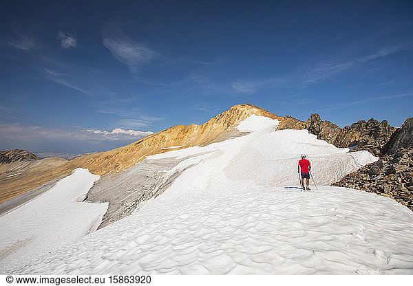 Hiker approaches Ochre Mountain via south glacier.