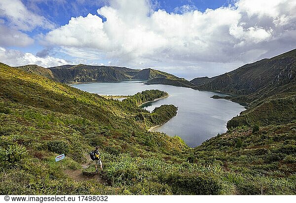Hiker at the crater rim with view to the crater lake Lagoa do Fogo  Sao Miguel Island  Azores  Portugal  Europe