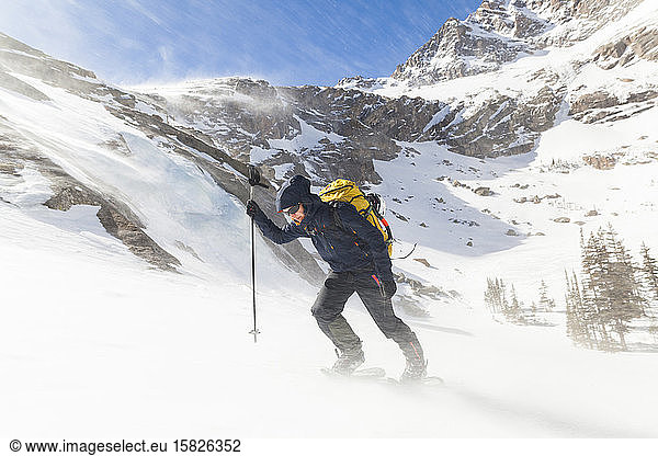 Hiker battles wind above Black Lake  Rocky Mountain National Park