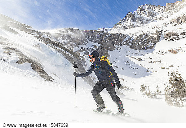 Hiker battles wind above Black Lake  Rocky Mountain National Park