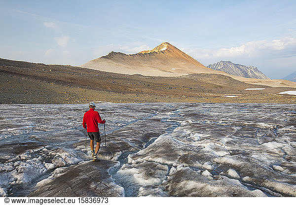 hiker crosses glacier towards Ochre Mountain.