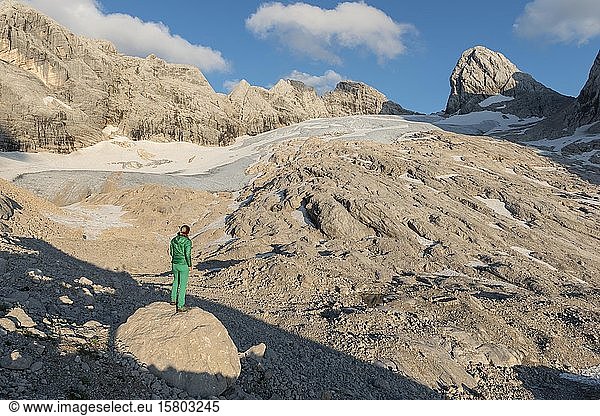 Hiker looks at alpine landscape  Great Gosau Glacier  Mitterspitz High and Low Dachstein  Salzkammergut  Upper Austria  Austria  Europe